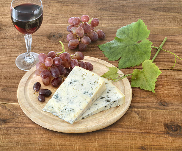 Cheese, grapes and wine on wood stock photo