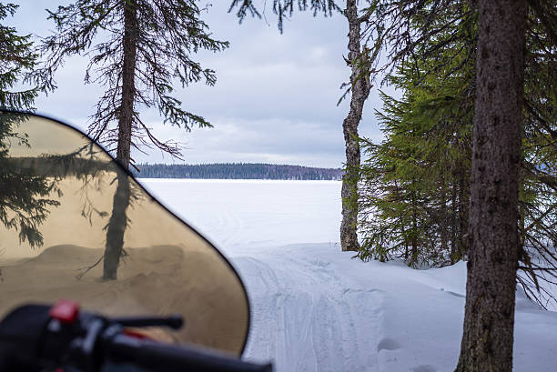 istock Snowmobile heading for frozen lake 465624298