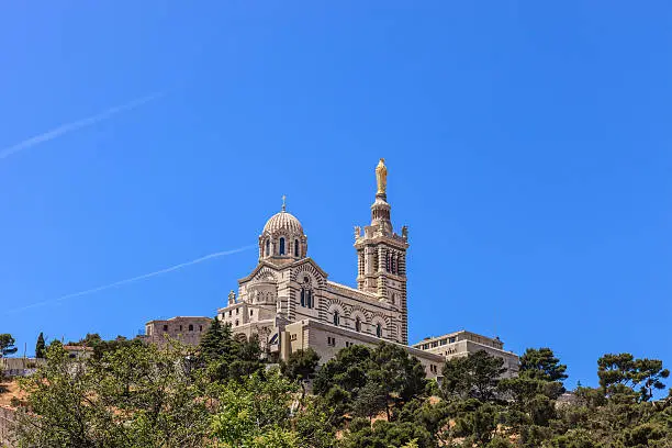 Notre-Dame de la Garde is a Neo-Byzantine church built on the foundations of an ancient fort at 154 meters high on the limestone outcrop of the Garde. It is a landmark of Marseille, visible from far away, and a pilgrimage site on Assumption Day, August 15.