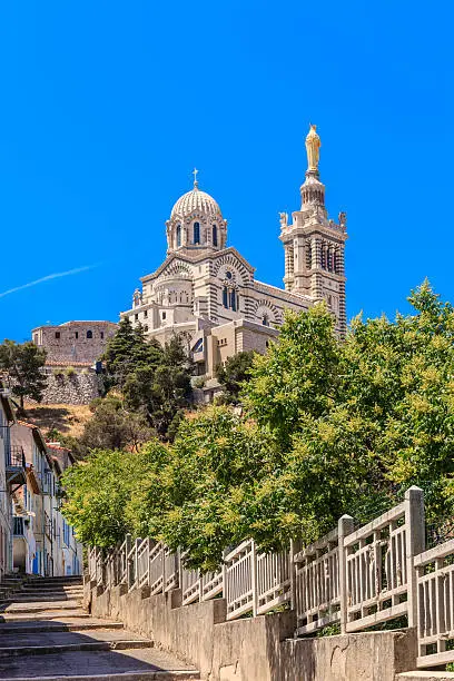Notre-Dame de la Garde is a Neo-Byzantine church built on the foundations of an ancient fort at 154 meters high on the limestone outcrop of the Garde. It is a landmark of Marseille, visible from far away, and a pilgrimage site on Assumption Day, August 15.