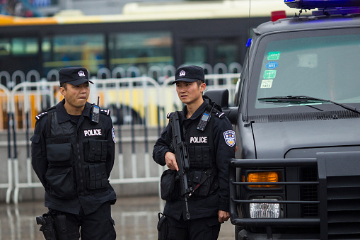 Guangzhou, Сhina - March 6, 2015: Armed paramilitary policemen stand guard in front of the Guangzhou Railway Station after a knife attack, in Guangzhou, Guangdong province, March 6, 2015. Knife-wielding attackers slashed and stabbed people at a railway station in the southern Chinese city of Guangzhou, wounding at least nine before police shot dead one of the suspected assailants and arrested another. 