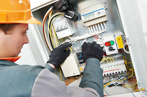 istock Caucasian electrician with orange hat fixing wire box 465624916