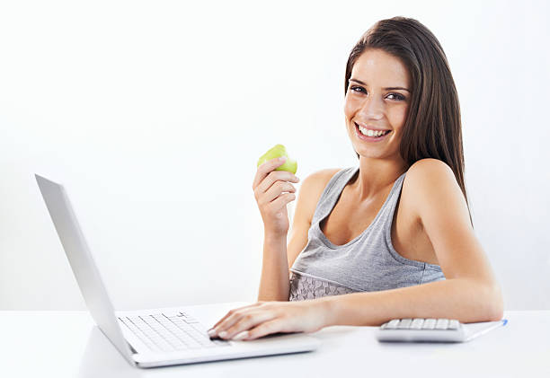 istock She needs to keep her energy up whle online! 465629215