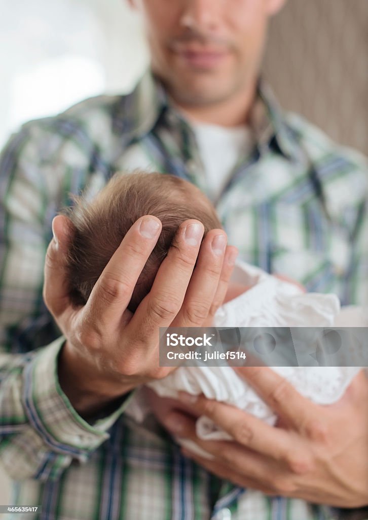 Newborn with a dress in her father's arms Newborn girl in a  dress sleeping in her father's arms 0-1 Months Stock Photo