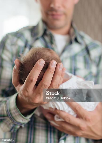 Newborn With A Dress In Her Fathers Arms Stock Photo - Download Image Now - 0-1 Months, 0-11 Months, Adult