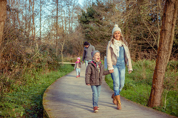 istock Happy family walking together holding hands in the forest 465635538