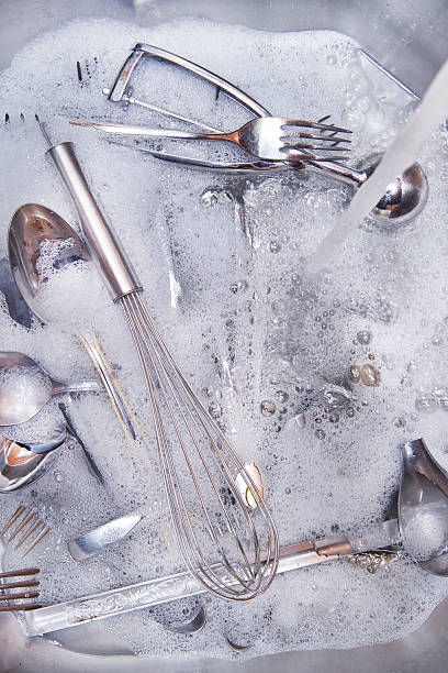 istock kitchen sink with cutlery to be washed 465636673