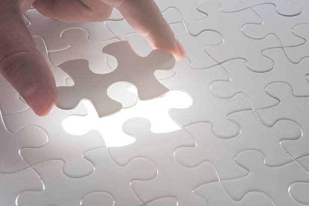 istock Hand holding the last piece of jigsaw puzzle 465641897