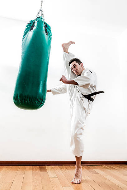 homme faisant arts martiaux - karate punching bag caucasian leisure activity photos et images de collection