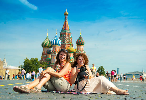 istock Happy young woman lying on Red Square 465643237