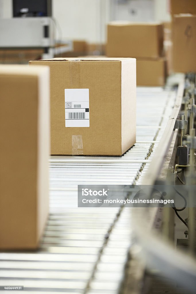 Goods On Conveyor Belt In Distribution Warehouse Goods Moving On Conveyor Belt In Distribution Warehouse Box - Container Stock Photo