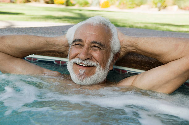 istock Man Relaxing At The Edge Of Swimming Pool 465645229