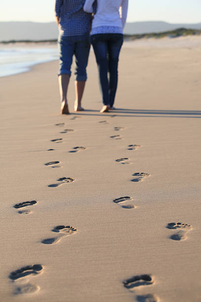 istock Couple taking a stroll along the beach 465646003