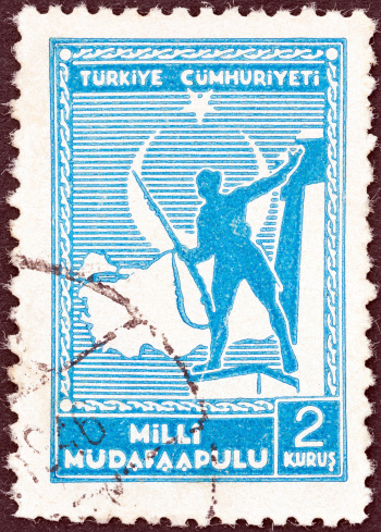 TURKEY - CIRCA 1941: A stamp printed in Turkey shows soldier and Map of Turkey, circa 1941.
