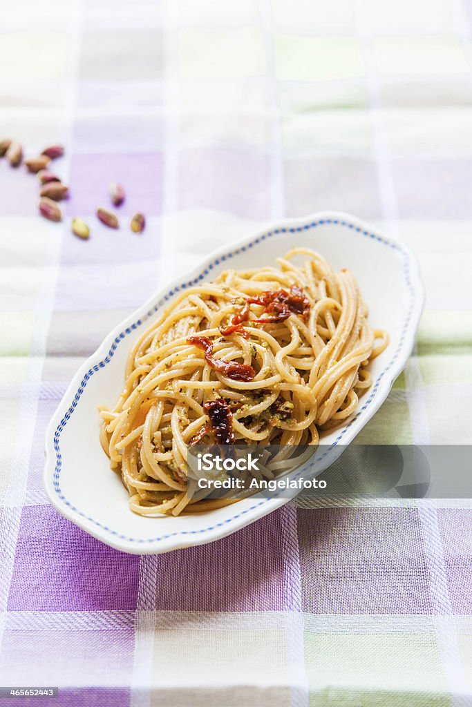 Spaghetti and Pistachio Pesto Spaghetti with pistachio pesto eand dried tomatoes. Genoese Stock Photo
