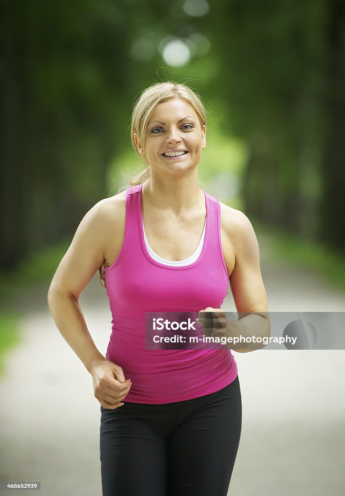 Portrait of an active young woman jogging in the park Close up portrait of an active young woman jogging in the park 20-24 Years Stock Photo