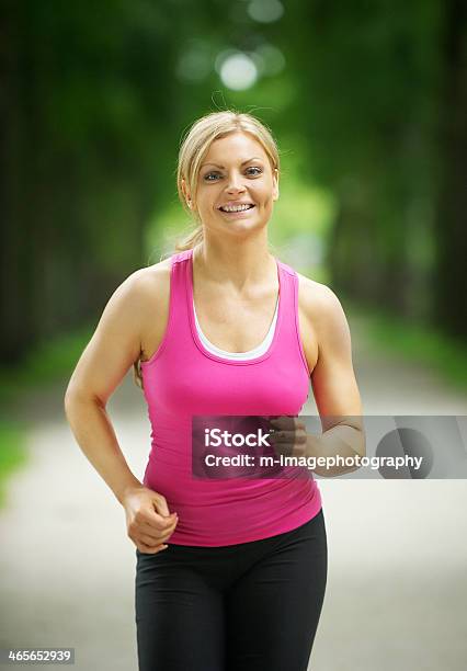 Portrait Of An Active Young Woman Jogging In The Park Stock Photo - Download Image Now