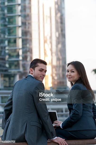Businessman And Woman Working On Laptop In Financial District Stock Photo - Download Image Now