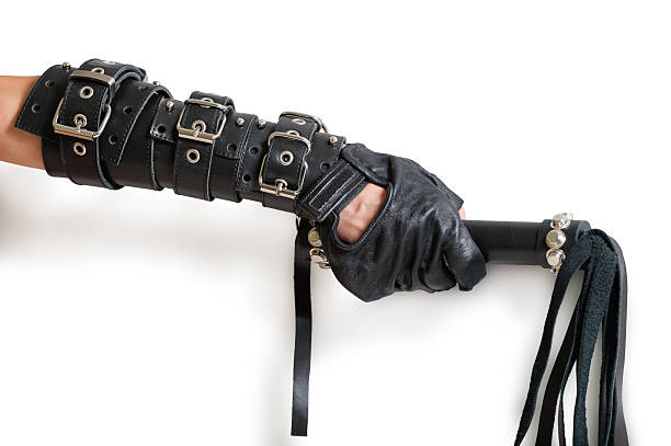 istock Hand in leather glove with lash and shadow 465656663