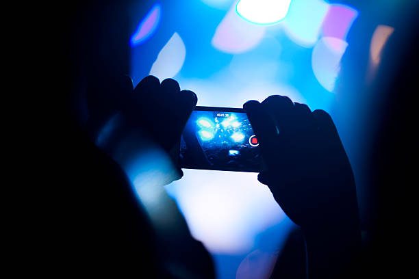 istock Spectator filming concert with smartphone 465658559