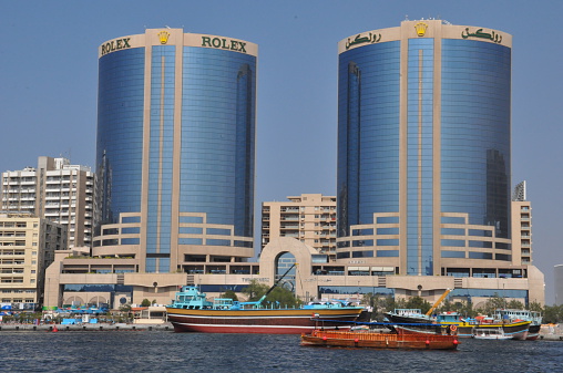 Dubai, UAE - February 13, 2014: The Twin Towers of Dubai Creek in Dubai, UAE. Also known as Rolex Towers, each building is 102 metres (335 ft) in height and has 22 floors.
