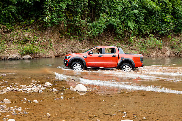 Ford Ranger Wildtrak 3.2L Lang Son, Viet Nam - Nov 4, 2014: Ford Ranger Wildtrak crossing river in Vietnam ford crossing stock pictures, royalty-free photos & images