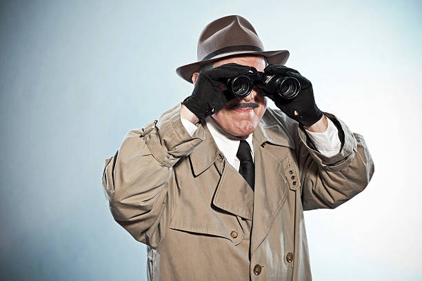 istock Vintage detective with mustache and hat. Looking through binoculars. 465663679