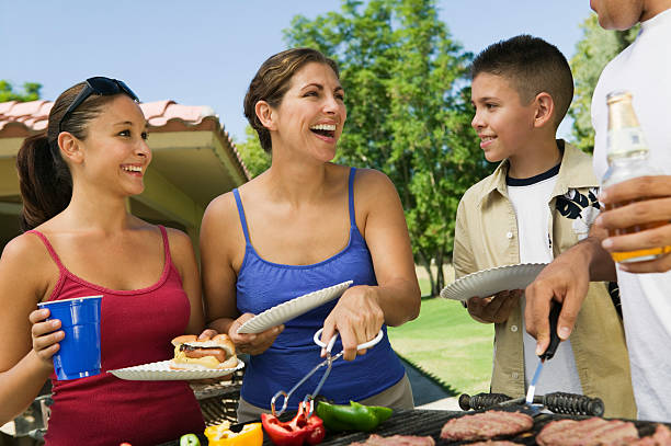 istock Family Gathered Around Grill 465664337