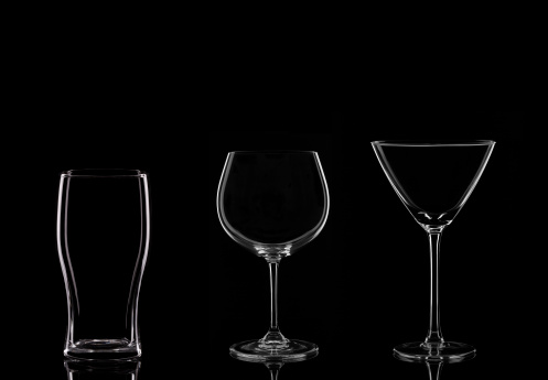 A Martini Glass, a Wine Glass and a Pint Glass on a Black Background