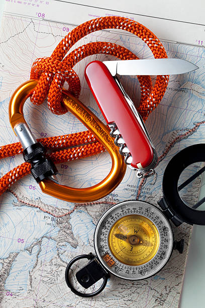 istock Compass on topographic map with rope climbing and knife. 465667147