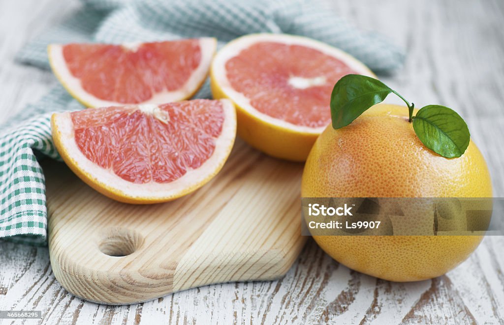 grapefruit ripe grapefruits with leaves  on wooden  background Grapefruit Stock Photo