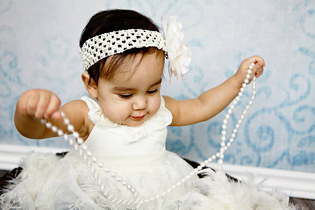 istock Baby Girl Playing with Pearls 465669773