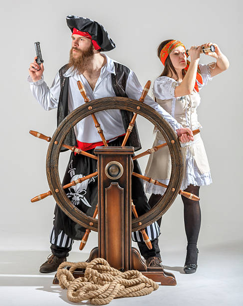 Comical pirate couple at the helm the ship