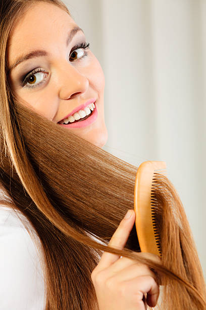 istock beautiful woman with long hair and comb 465670802