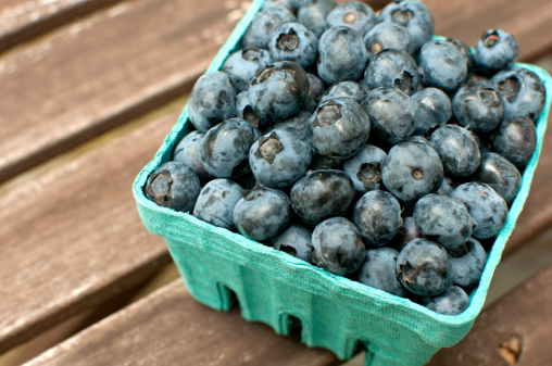 Carton box with fresh ripe blueberries outside