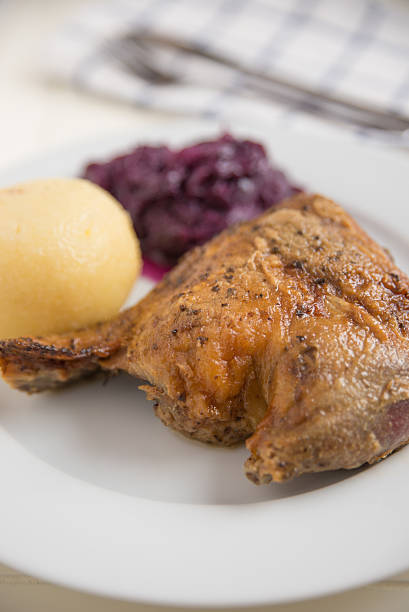 istock Roast duck legs with potato dumplings and red cabbage 465671284