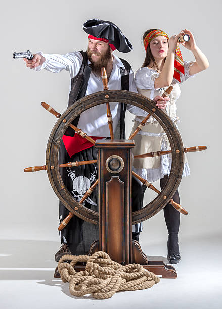 istock Funny pirates at ship steering wheel 465673362