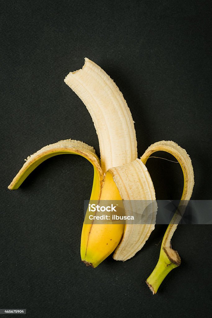 Yellow banana on black paper background, minimalist still life 2015 Stock Photo