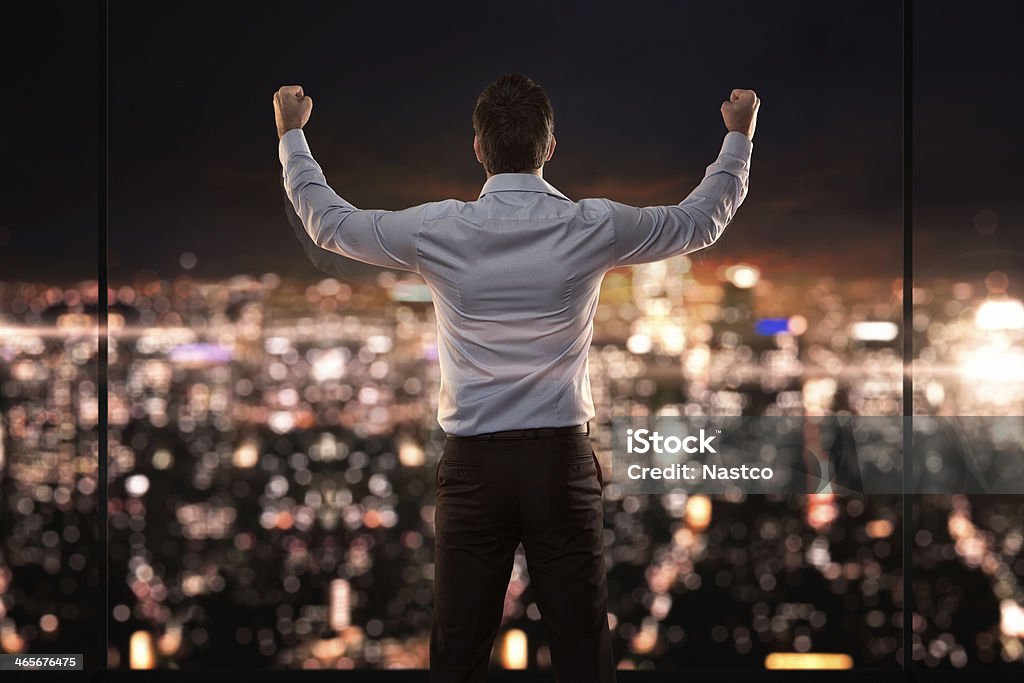 King of the world Young successful businessman standing in front of the city Passion Stock Photo