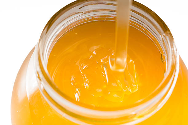 istock image of jar of honey isolated on white background 465676592
