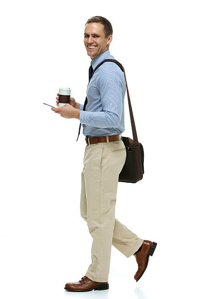 istock Smiling businessman holding coffee cup walking 465680018