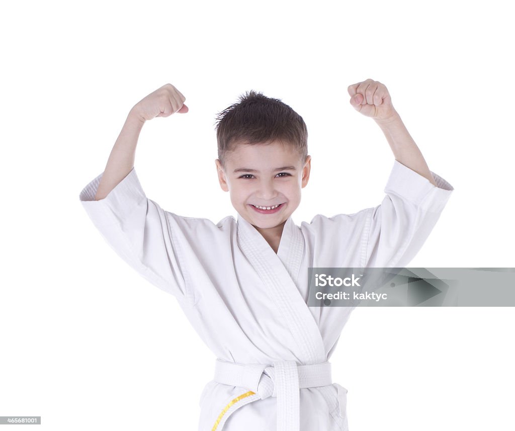 Young boy fighter in kimono with hand up Young boy fighter in kimono with hand up isolated on white background Child Stock Photo