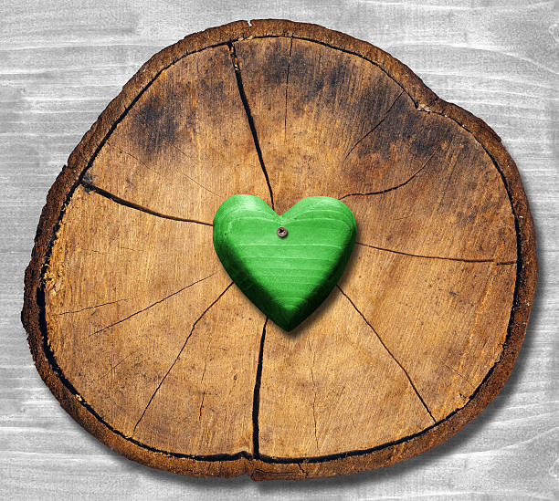 Wooden heart on kraft paper background with inscription love With sunlight and colored bokeh Copy space Wedding invitation card Valentine Birthday Defocused bokeh effect Front view