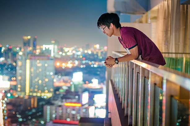 istock Men standing on the rooftop of a skyscraper over  cityscape 465682354
