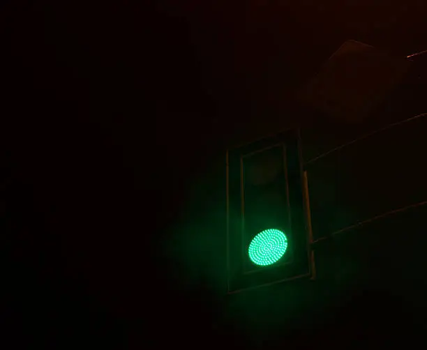 Green light on semaphore at the night