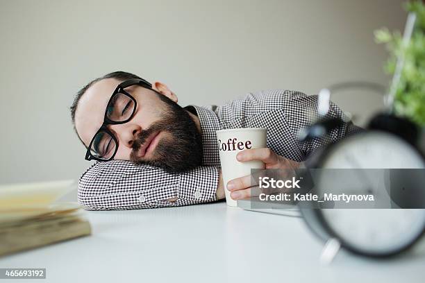 Man Sleeps On Office Table Over Laptop With Coffee Stock Photo - Download Image Now - Coffee - Drink, Tired, Sleeping