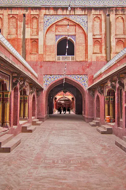 The Wazir Khan Mosque  in Lahore, Pakistan, is famous for its extensive faience tile work. It has been described as 'a mole on the cheek of Lahore'. It was built in seven years, starting around 1634–1635 AD, during the reign of the Mughal Emperor Shah Jehan. It was built by Hakim Shaikh Ilm-ud-din Ansari, a native of Chiniot, who rose to be the court physician to Shah Jahan and a governor of Lahore. He was commonly known as Wazir Khan, a popular title bestowed upon him (the word Wazir means 'minister' in Urdu and Persian). The mosque is inside the Inner City and is easiest accessed from Delhi Gate. The mosque contains some of the finest examples of Qashani tile work from the Mughal period.