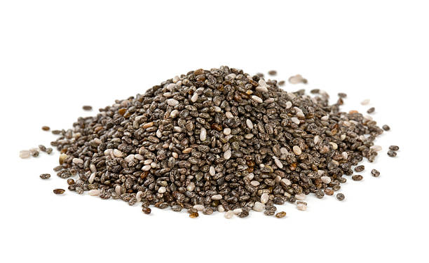 Pile of chia seeds on white surface stock photo