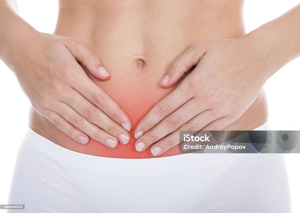 Woman Suffering From Stomach Ache Young Woman With Pain In Her Stomach Isolated Over White Background One Woman Only Stock Photo