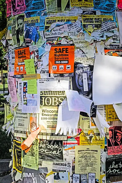 Madison, WI, USA - June 10, 2007: Flyers and leaflets stuck all over this informatio board on the University of Wisconsin Madison campus WI